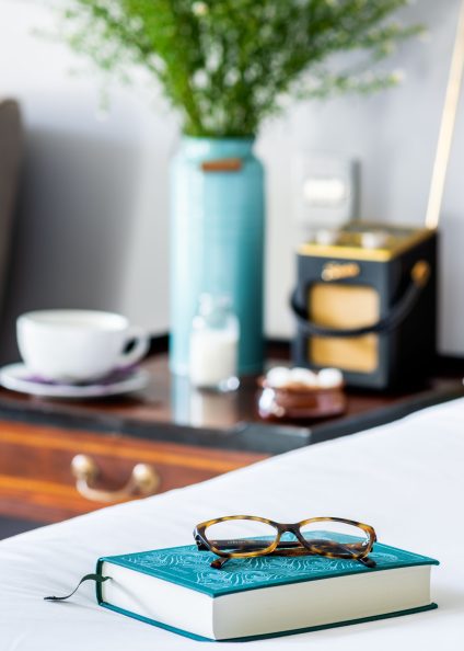 Book and glasses on bed