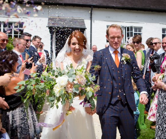 Bride and groom outside with confetti