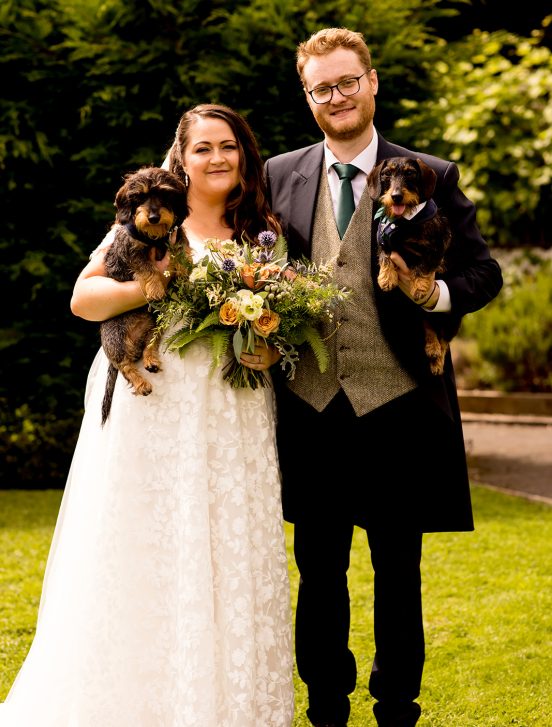 Bride and groom posing with dogs