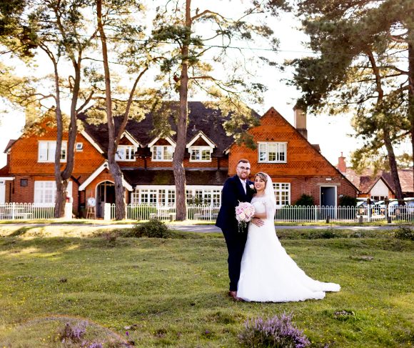 Bride and groom posing outside of Beaulieu Inn