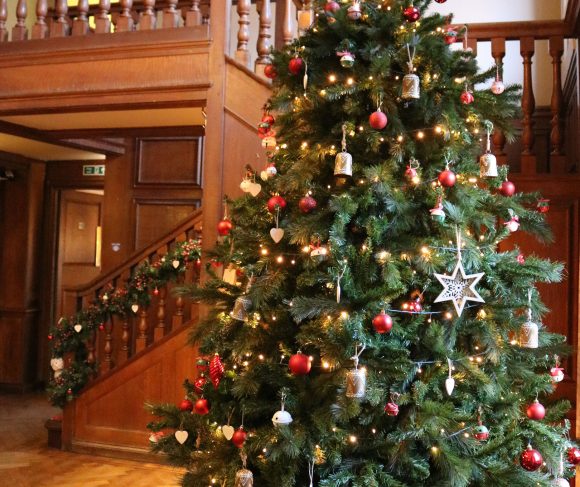Christmas tree with decorations by staircase