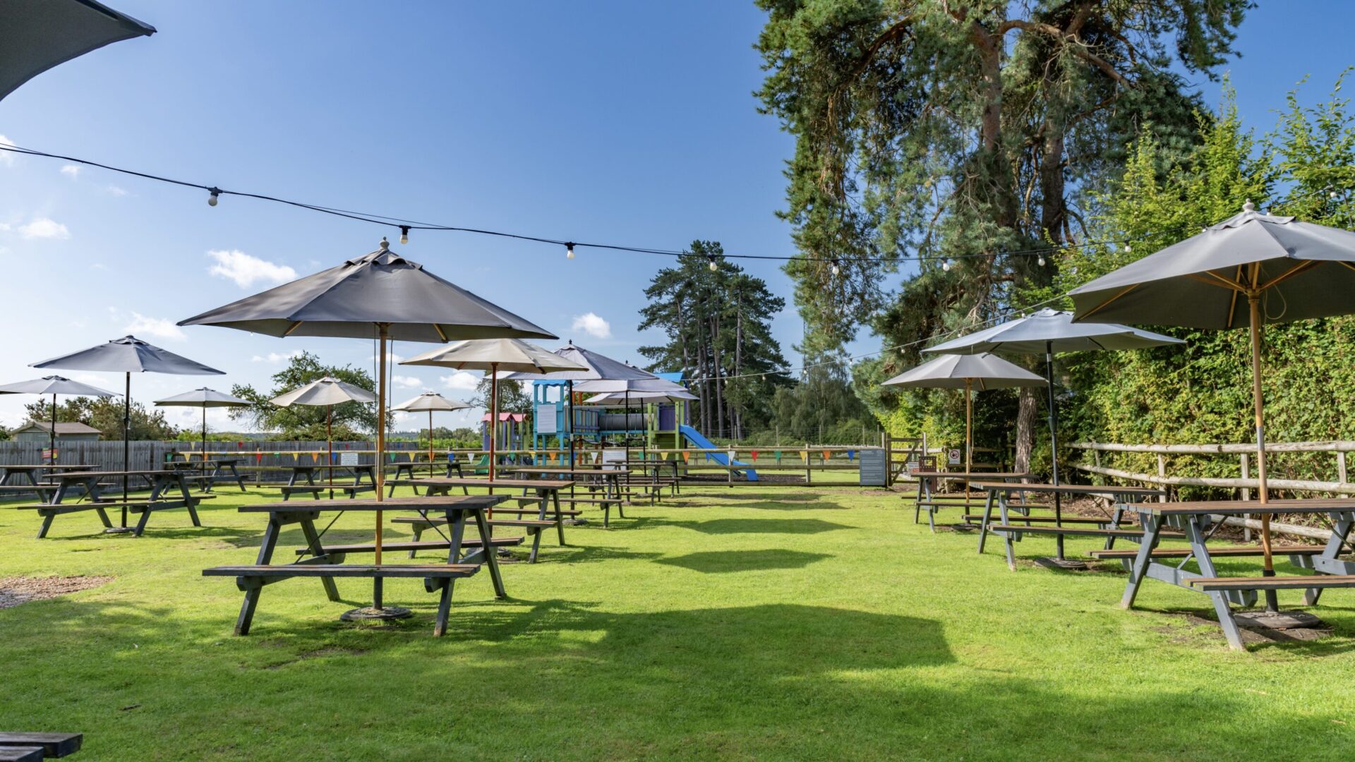 Guests relaxing in the garden at The Drift Inn, next to Beaulieu Hotel in the New Forest