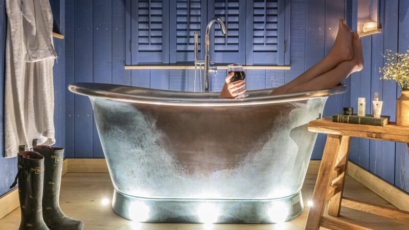 Freestanding bath inside a luxury shepherd’s hut at Burley Manor in the New Forest