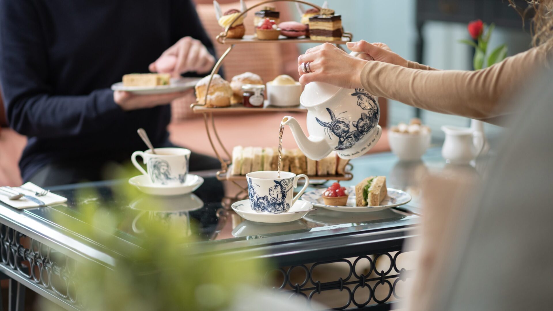 Elegant afternoon tea set-up with cakes, scones, and tea in Bartley Lodge dining room