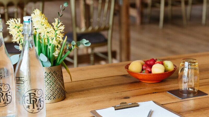 Burley Manor meeting room with natural light, wooden beams, and conference-style seating