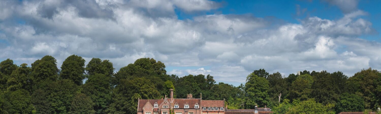 The welcoming exterior of Burley Manor, a historic hotel nestled in the heart of the New Forest, offering guests a charming blend of heritage, natural beauty, and warm hospitality from the moment they arrive.