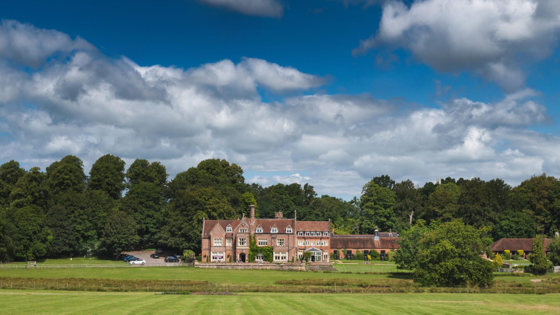 The welcoming exterior of Burley Manor, a historic hotel nestled in the heart of the New Forest, offering guests a charming blend of heritage, natural beauty, and warm hospitality from the moment they arrive.